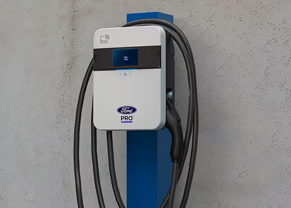 Ford Pro electric vehicle charger mounted on a wall, featuring a sleek design and charging cable.