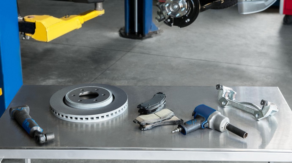 Mechanic adjusting a car engine throttle body, enhancing vehicle performance.
